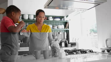 Mum helping son with breakfast