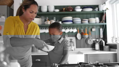 Mum helping son with breakfast