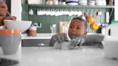 Boy playing at breakfast time 