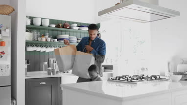 Father and Son carrying grocery bags home