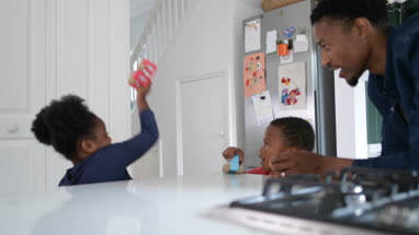 Brother and Sister playing with toy cars