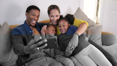 Family taking a selfie with a smartphone