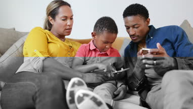 Family playing games on smartphone