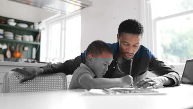 Father helping Son with school work