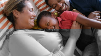 Mother and Father tickling son