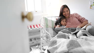 Mother reading Daughter a bedtime story