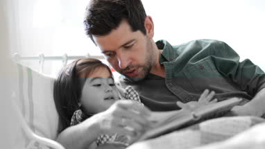 Father reading Daughter a bedtime story