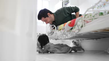 Girl playing hide and seek with Dad