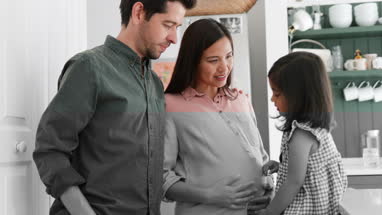 Pregnant mother with daughter and family