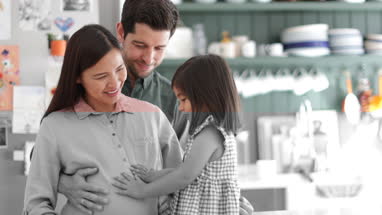 Pregnant mother with daughter and family