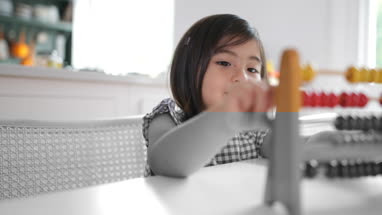 Girl using abacus to count
