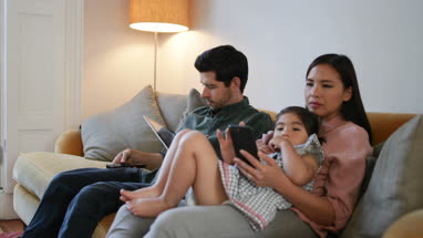 Family using technology devices
