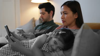 Family using technology devices