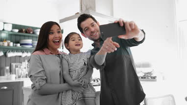 Family taking a selfie with a smartphone
