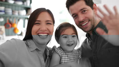 Family waving on a videocall with family