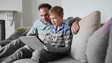 Father and Son looking at a digital tablet