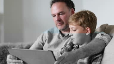 Close-up Father and Son looking at a digital tablet