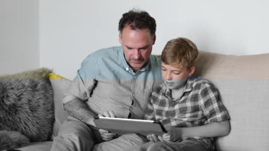 Father and Son looking at a digital tablet