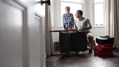 Father teaching Son how to fix a chair
