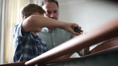 Father teaching Son how to fix a chair