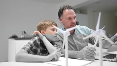 Father helping son with school project