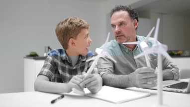 Father helping son with school project