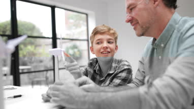 Son telling Father about his school project