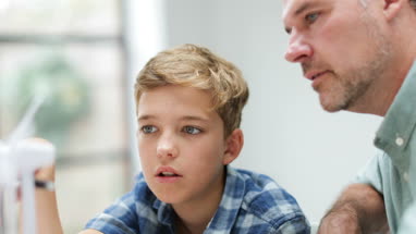 Father helping son with school project