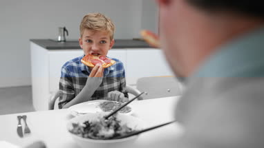 Father having pizza with his Son
