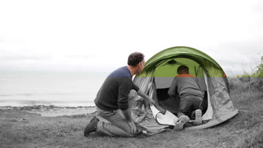 Father and Son setting up a tent together