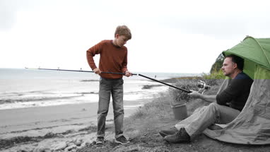 Father teaching Son how to fish