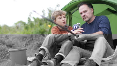 Father teaching Son how to fish