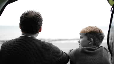 Father and Son camping on beach together