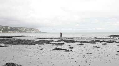 Father and Son walking on natural beach
