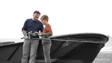 Father teaching Son how to fish