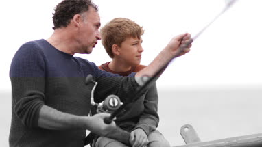 Father teaching Son how to fish