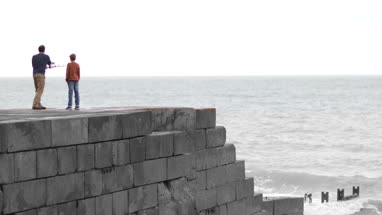 Father passing Son fishing rod