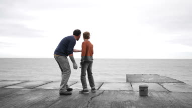 Father helping Son fish