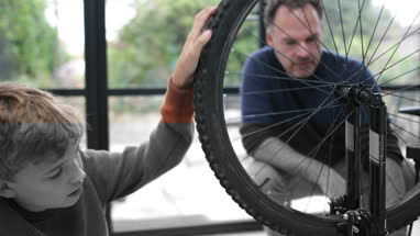 Father teaching Son how to care for his bicycle