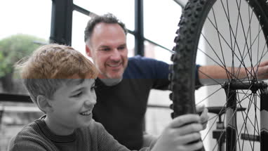 Father teaching Son how to care for his bicycle
