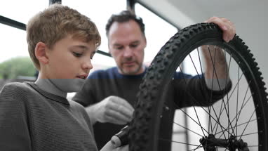 Father teaching Son how to pump bike tyres