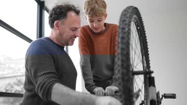 Father teaching Son how to care for his bicycle