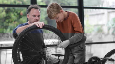 Father teaching Son how to pump bike tyres