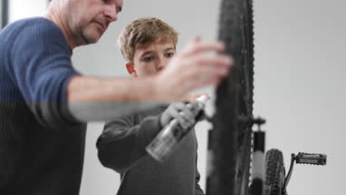 Father teaching Son how to fit new brakes on a bike