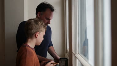 Father teaching Son how to decorate