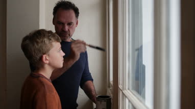 Son helping Father to decorate