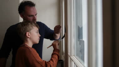 Son helping Father to decorate