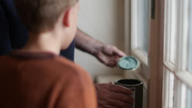 Father teaching Son how to decorate