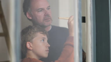 Son helping Father to decorate