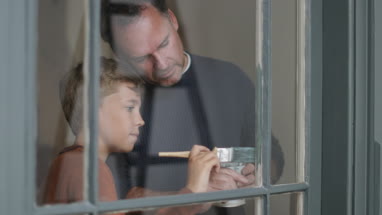 Son helping Father to decorate